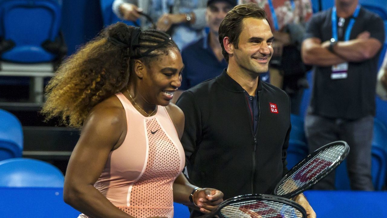 Roger Federer of Switzerland (R) stands alongside Serena Willams of the US (L) following their mixed mixed doubles match in their sixth session on day four of the Hopman Cup tennis tournament in Perth January 1, 2019.