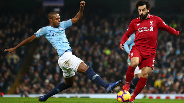 MANCHESTER, ENGLAND - JANUARY 03: Mohamed Salah of Liverpool is challenged by Fernandinho of Manchester City during the Premier League match between Manchester City and Liverpool FC at the Etihad Stadium on January 3, 2019 in Manchester, United Kingdom.