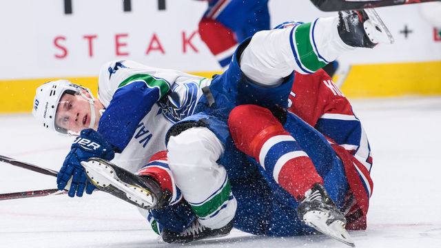 MONTREAL, QC - JANUARY 03: Vancouver Canucks center Elias Pettersson (40) twists his right ankle while falling on Montreal Canadiens center Jesperi Kotkaniemi (15) during the second period of the NHL game between the Vancouver Canucks and the Montreal Canadiens on January 03, 2019, at the Bell Centre in Montreal, QC