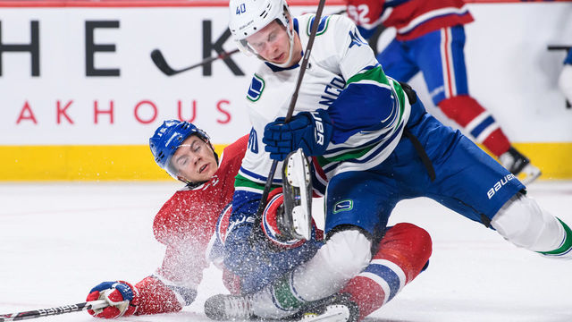 MONTREAL, QC - JANUARY 03: Vancouver Canucks center Elias Pettersson (40) twists his right ankle while falling on Montreal Canadiens center Jesperi Kotkaniemi (15) during the second period of the NHL game between the Vancouver Canucks and the Montreal Canadiens on January 03, 2019, at the Bell Centre in Montreal, QC