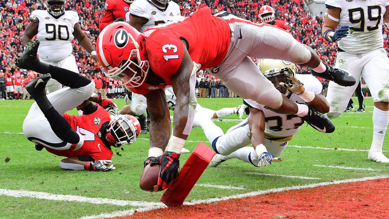 ATHENS, GA - NOVEMBER 24: Elijah Holyfield #13 of the Georgia Bulldogs scores a second quarter touchdown against the Georgia Tech Yellow Jackets on November 24, 2018 at Sanford Stadium in Athens, Georgia.