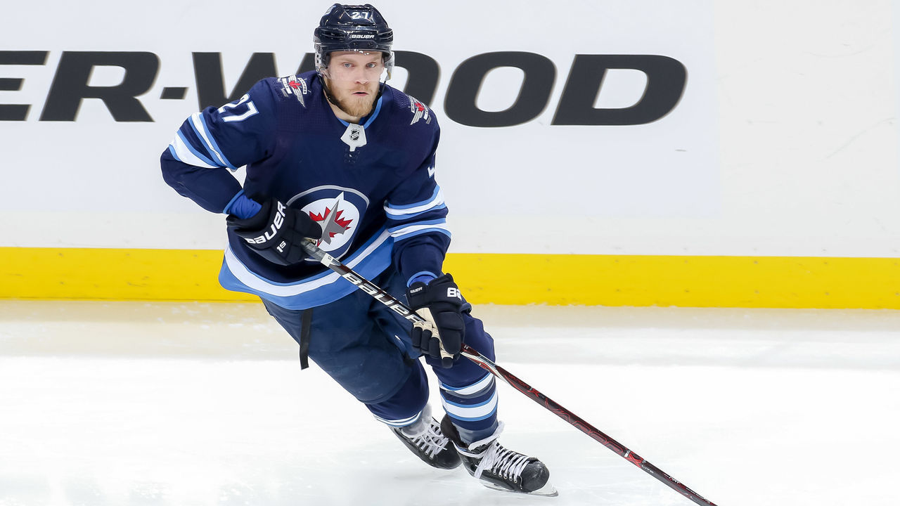 WINNIPEG, MB - DECEMBER 27: Nikolaj Ehlers #27 of the Winnipeg Jets plays the puck down the ice during third period action against the Calgary Flames at the Bell MTS Place on December 27, 2018 in Winnipeg, Manitoba, Canada. The Flames defeated the Jets 4-1.
