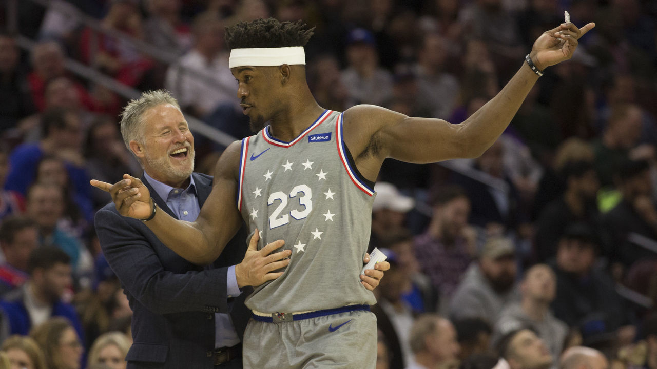 PHILADELPHIA, PA - NOVEMBER 30: Head coach Brett Brown of the Philadelphia 76ers shares a laugh with Jimmy Butler #23 in the third quarter against the Washington Wizards at the Wells Fargo Center on November 30, 2018 in Philadelphia, Pennsylvania. The 76ers defeated the Wizards 123-98.