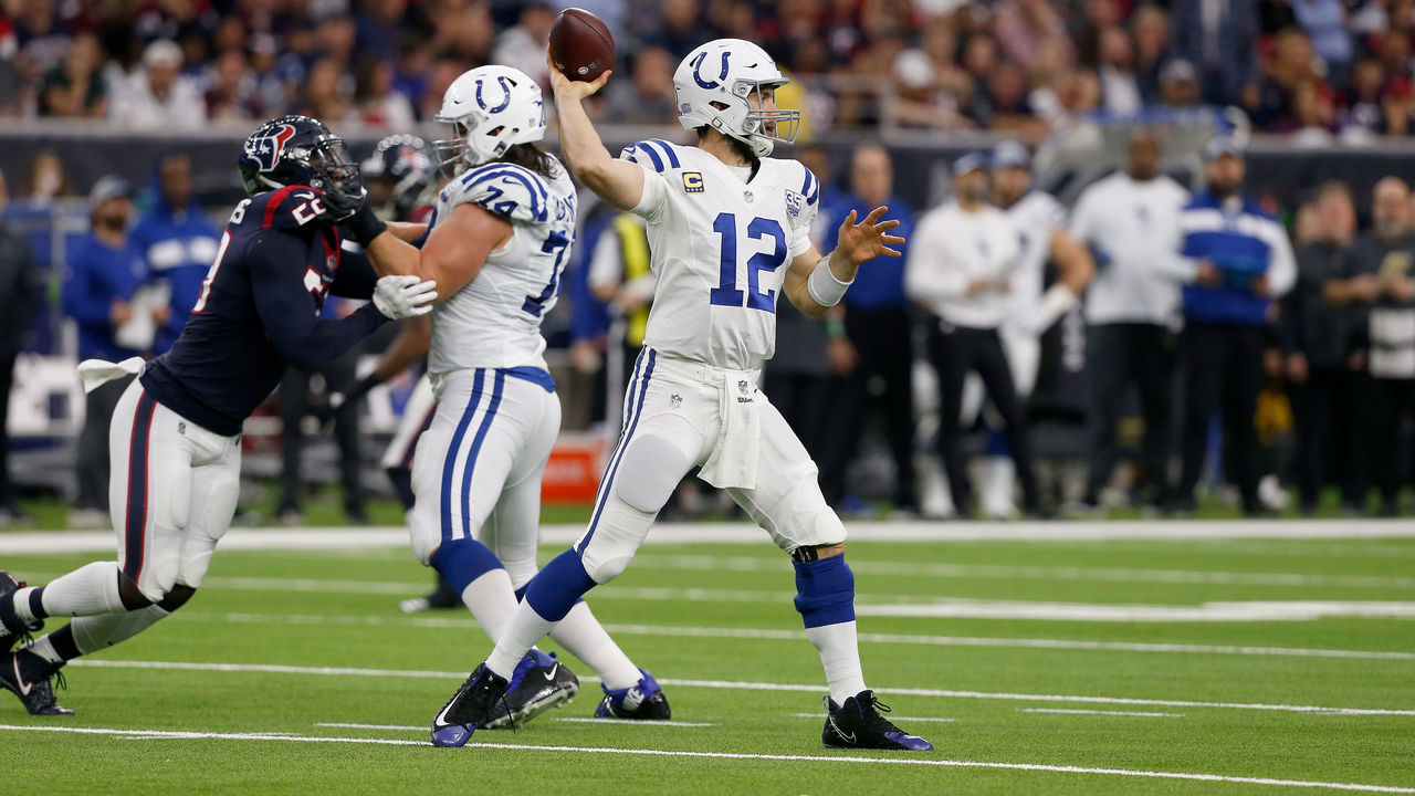 HOUSTON, TX - JANUARY 05: Andrew Luck #12 of the Indianapolis Colts throws the ball pressured by Whitney Mercilus #59 of the Houston Texans in the second quarter during the Wild Card Round at NRG Stadium on January 5, 2019 in Houston, Texas.