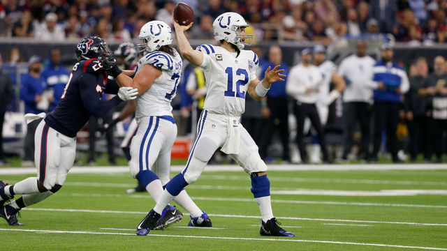 HOUSTON, TX - JANUARY 05: Andrew Luck #12 of the Indianapolis Colts throws the ball pressured by Whitney Mercilus #59 of the Houston Texans in the second quarter during the Wild Card Round at NRG Stadium on January 5, 2019 in Houston, Texas.