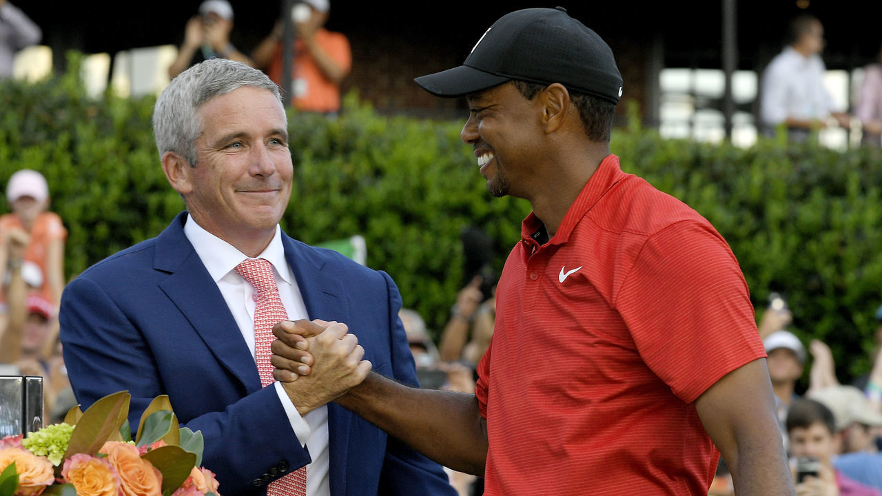 ATLANTA, GA - SEPTEMBER 23: PGA TOUR Commissioner Jay Monahan congratulates Tiger Woods after the final round of the TOUR Championship at East Lake Golf Club on September 23, 2018, in Atlanta, Georgia.