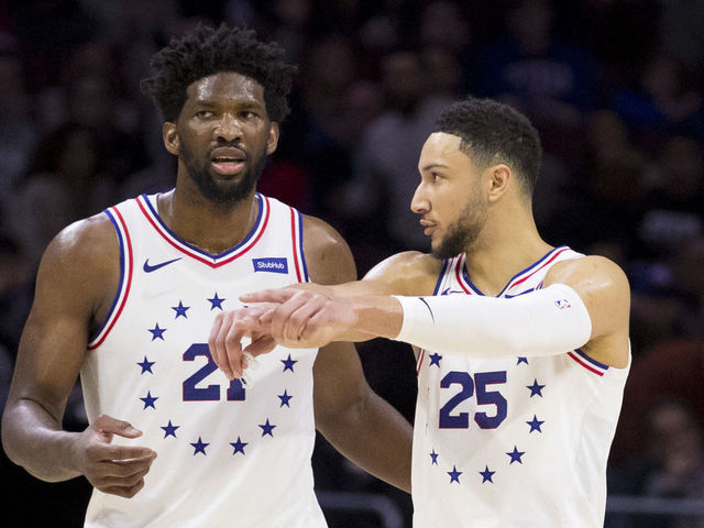 PHILADELPHIA, PA - JANUARY 05: Joel Embiid #21 of the Philadelphia 76ers talks to Ben Simmons #25 in the fourth quarter against the Dallas Mavericks at Wells Fargo Center on January 5, 2019 in Philadelphia, Pennsylvania. The 76ers defeated the Mavericks 106-100.