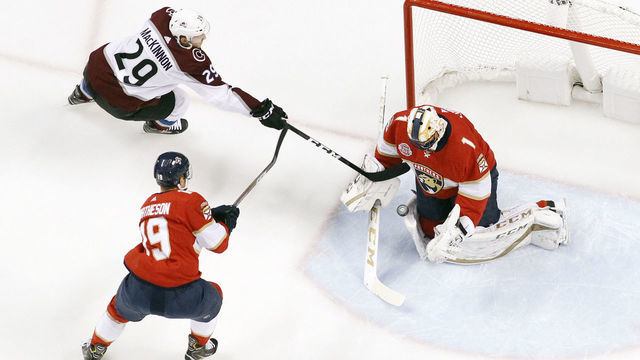 SUNRISE, FL - DECEMBER 06: Michael Matheson #19 looks on as goaltender Roberto Luongo #1 of the Florida Panthers stops a shot by Nathan MacKinnon #29 of the Colorado Avalanche during first period action at the BB&T Center on December 6, 2018 in Sunrise, Florida. The Avalanche defeated the Panthers 5-2.