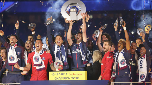 PARIS, FRANCE - MAY 12: Thiago Silva and Thiago Motta of PSG (center) surrounded by teammates Javier Pastore, Layvin Kurzawa, Alphonse Areola, Lassana Diarra, Kevin Trapp, Presnel Kimpembe, Kylian Mbappe, Neymar Jr celebrate during the French Ligue 1 Championship Trophy Ceremony following the Ligue 1 match between Paris Saint-Germain (PSG) and Stade Rennais (Rennes) at Parc des Princes stadium on May 12, 2018 in Paris, France.