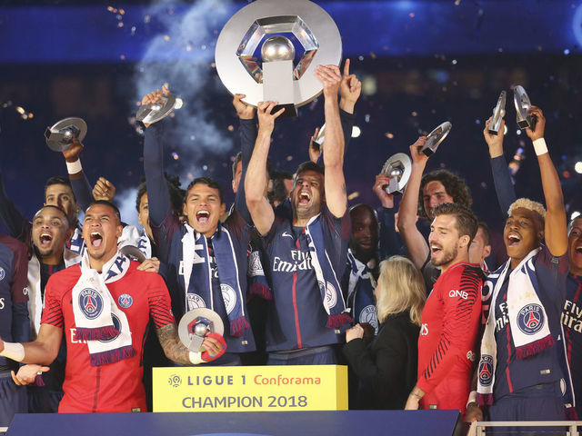 PARIS, FRANCE - MAY 12: Thiago Silva and Thiago Motta of PSG (center) surrounded by teammates Javier Pastore, Layvin Kurzawa, Alphonse Areola, Lassana Diarra, Kevin Trapp, Presnel Kimpembe, Kylian Mbappe, Neymar Jr celebrate during the French Ligue 1 Championship Trophy Ceremony following the Ligue 1 match between Paris Saint-Germain (PSG) and Stade Rennais (Rennes) at Parc des Princes stadium on May 12, 2018 in Paris, France.