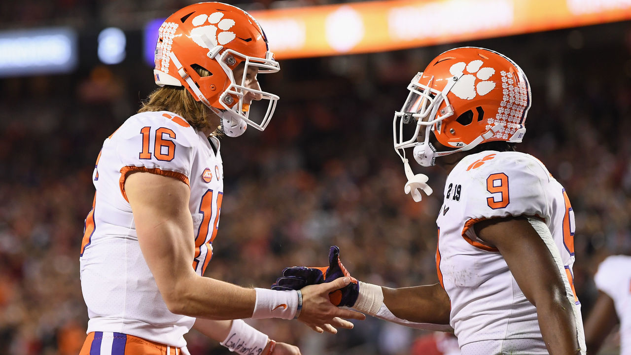 SANTA CLARA, CA - JANUARY 07: Trevor Lawrence #16 and Travis Etienne #9 of the Clemson Tigers celebrate their second quarter touchdown against the Alabama Crimson Tide in the CFP National Championship presented by AT&T at Levi's Stadium on January 7, 2019 in Santa Clara, California.