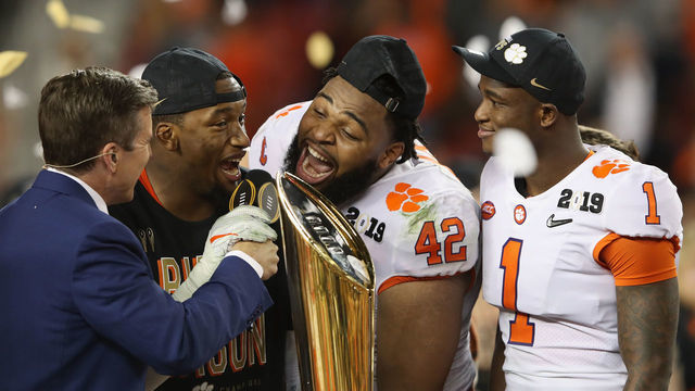 SANTA CLARA, CA - JANUARY 07: Christian Wilkins #42 of the Clemson Tigers celebrates with the trophy after his teams 44-16 win over the Alabama Crimson Tide in the CFP National Championship presented by AT&T at Levi's Stadium on January 7, 2019 in Santa Clara, California.