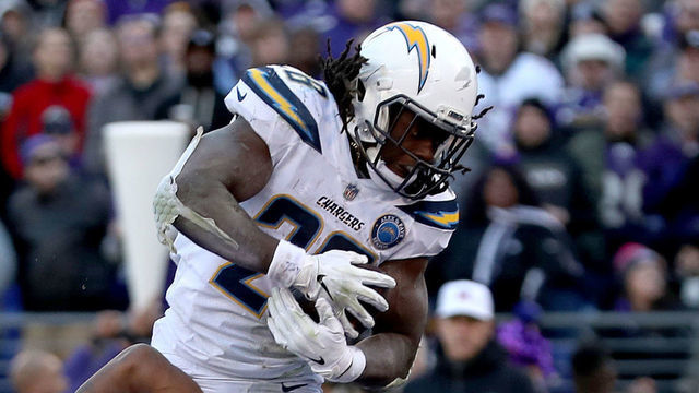 BALTIMORE, MARYLAND - JANUARY 06: Melvin Gordon #28 of the Los Angeles Chargers scores a one yard touchdown against the Baltimore Ravens during the fourth quarter in the AFC Wild Card Playoff game at M&T Bank Stadium on January 06, 2019 in Baltimore, Maryland.