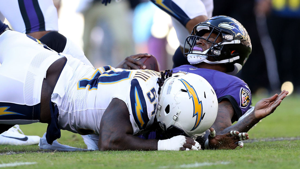 BALTIMORE, MARYLAND - JANUARY 06: Lamar Jackson #8 of the Baltimore Ravens gets sacked by Melvin Ingram #54 of the Los Angeles Chargers during the third quarter in the AFC Wild Card Playoff game at M&T Bank Stadium on January 06, 2019 in Baltimore, Maryland.