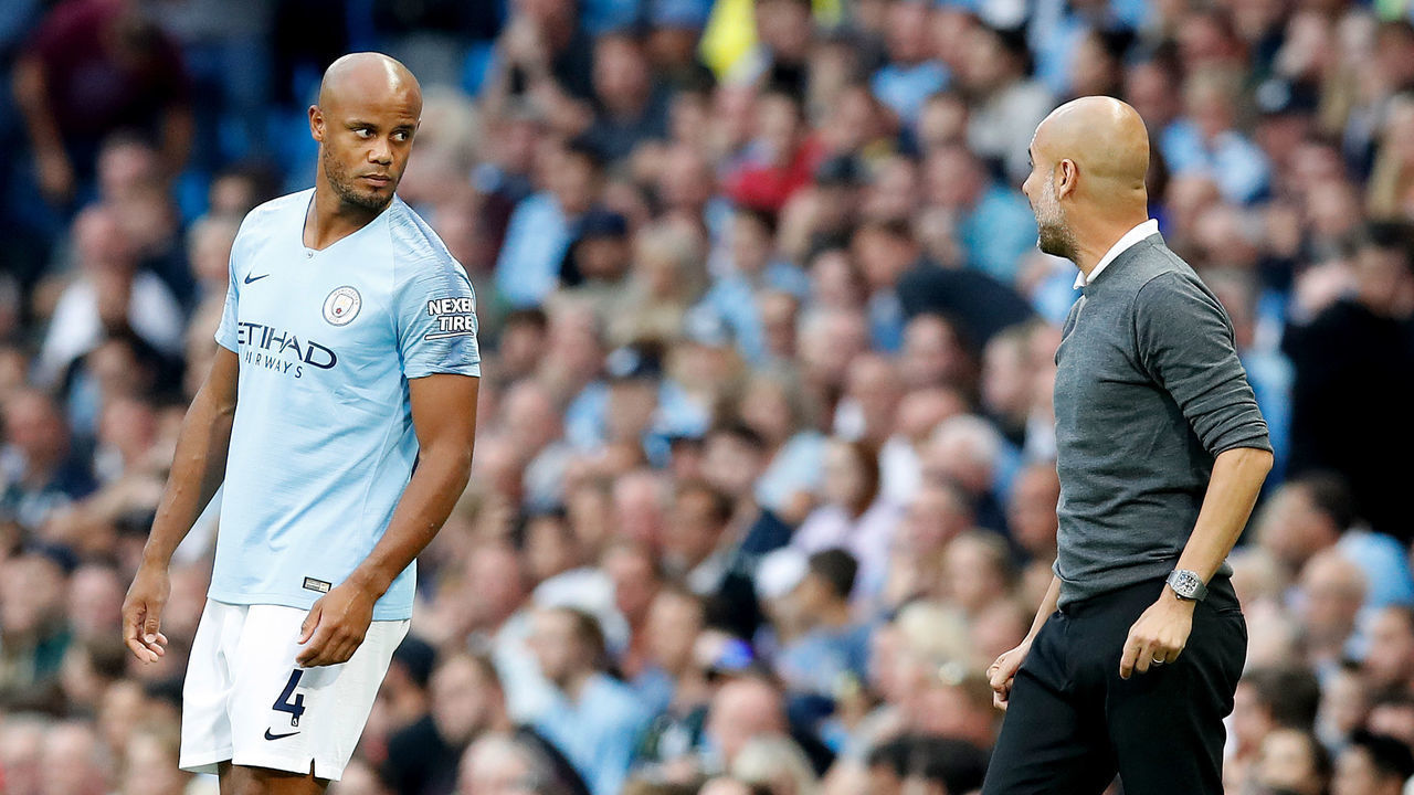 Manchester City manager Pep Guardiola (right) on the touchline as Manchester City's Vincent Kompany (left) waits to come on as a substitute during the Premier League match at the Etihad Stadium, Manchester.