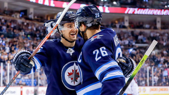 WINNIPEG, MB - JANUARY 8: Mark Scheifele #55 and Blake Wheeler #26 of the Winnipeg Jets celebrate a second period goal against the Colorado Avalanche at the Bell MTS Place on January 8, 2019 in Winnipeg, Manitoba, Canada.