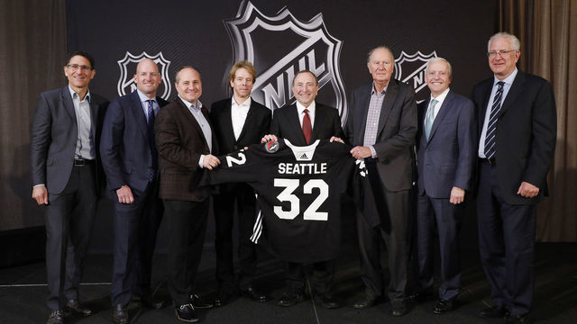 SEA ISLAND, GA - DECEMBER 04: (L to R) Adrian Hanauer, NHL Seattle franchise Vice-Chairman David Wright, Jay Deutsch, Jerry Bruckheimer, NHL Commissioner Gary Bettman, NHL Seattle franchise majority owner David Bonderman, Len Potter, and NHL Seattle franchise President and CEO Tod Leiweke pose for a photo during the NHL Board of Governors Meeting on December 4, 2018 in Sea Island, Georgia. The NHL Board of Governors approved expanding to Seattle, making the franchise the 32nd team in the league.
