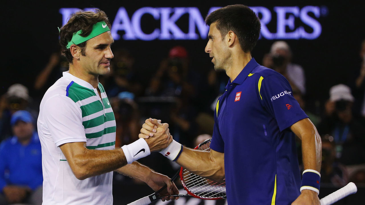 MELBOURNE, AUSTRALIA - JANUARY 28: Novak Djokovic of Serbia (R) shakes hands after winning in his semi final match against Roger Federer of Switzerland during day 11 of the 2016 Australian Open at Melbourne Park on January 28, 2016 in Melbourne, Australia.