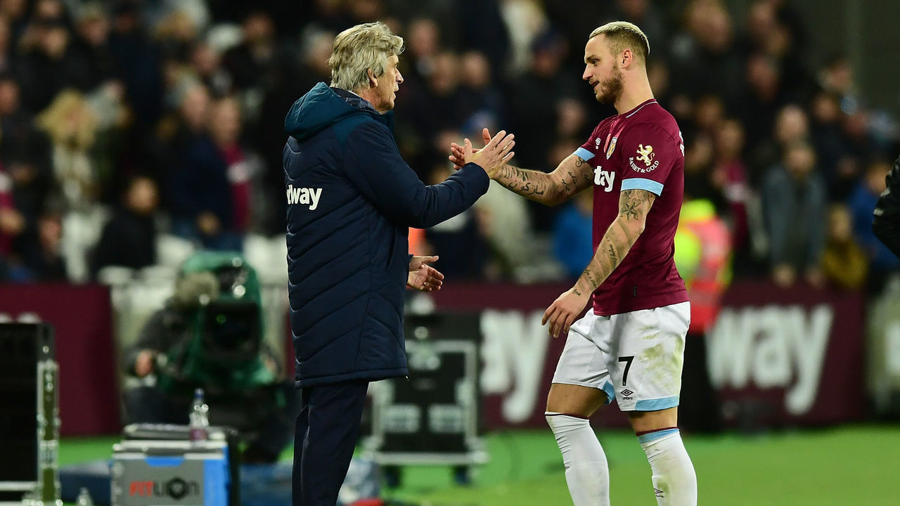 LONDON, ENGLAND - NOVEMBER 03: Manuel Pellegrini, Manager of West Ham United shakes hands with Marko Arnautovic of West Ham United as he is subbed during the Premier League match between West Ham United and Burnley FC at London Stadium on November 3, 2018 in London, United Kingdom.