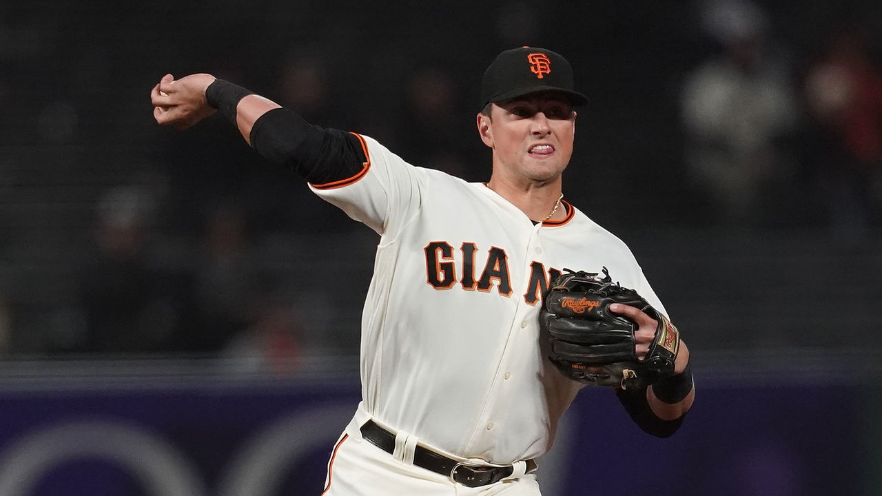 SAN FRANCISCO, CA - SEPTEMBER 25: Joe Panik #12 of the San Francisco Giants throws to first base to complete the double-play against the San Diego Padres in the top of the ninth inning at AT&T Park on September 25, 2018 in San Francisco, California.