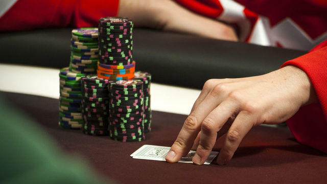 HANOVER, MD - MARCH 24: Greg Merson, of Laurel, who won the World Series of poker last year checks his hand at Maryland Live Casino Monday March 24, 2014 in Hanover, MD. He started the day with over $16,000 in chips.