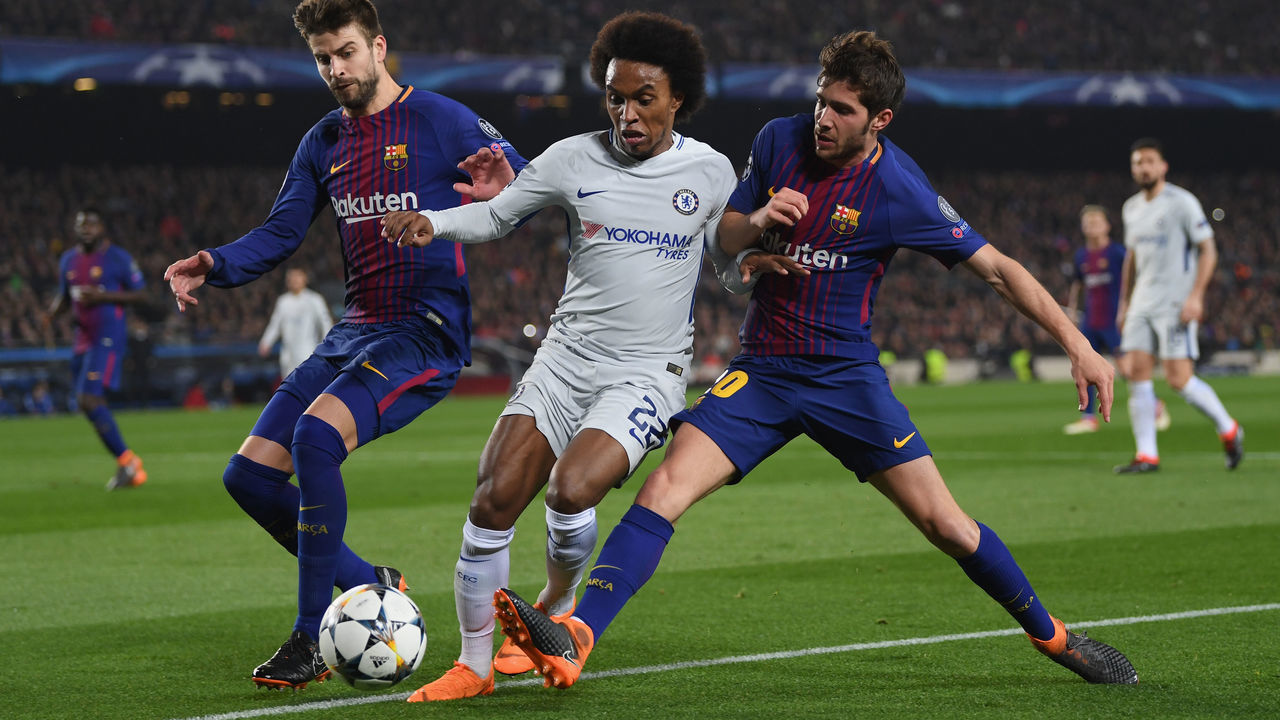 BARCELONA, SPAIN - MARCH 14: Willian of Chelsea battles with Gerard Pique and Sergi Roberto of Barcelona during the UEFA Champions League Round of 16 Second Leg match FC Barcelona and Chelsea FC at Camp Nou on March 14, 2018 in Barcelona, Spain.