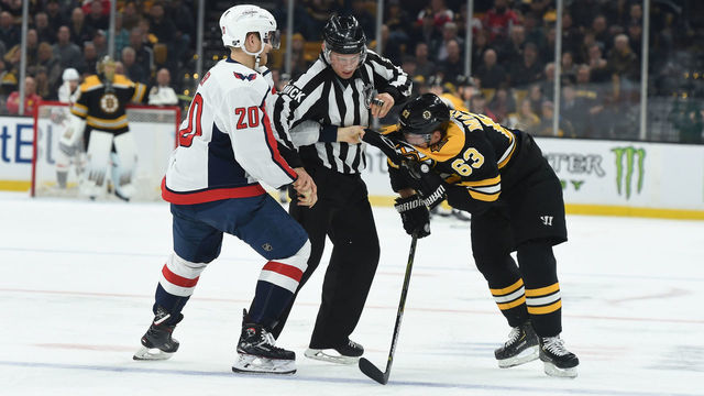 BOSTON, MA - JANUARY 10: Linesman Kory Nagy #97 tries to separate Brad Marchand #63 of the Boston Bruins from Lars Eller #20 of the Washington Capitals at the TD Garden on January 10, 2019 in Boston, Massachusetts.