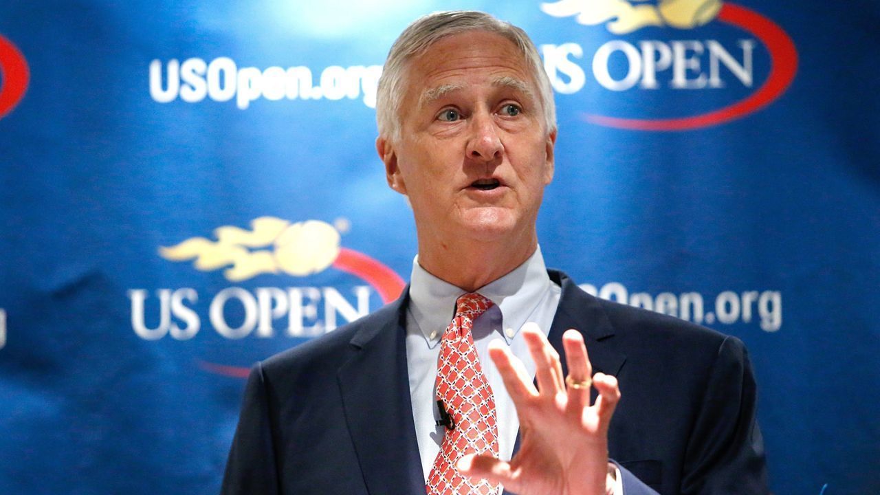 Gordon Smith, executive director USTA, speaks during a press conference at Arthur Ashe Stadium before the final piece of steel for the roof structure it's installed at the USTA Billie Jean King National Tennis Center in New York City on June 10, 2015. AFP PHOTO/ Kena Betancur