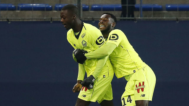 Lille's Ivorian forward Nicolas Pepe (L) celebrates scoring a goal with Lille's French forward Jonathan Bamba during the French L1 football match between Caen (SMC) and Lille (LOSC) on January 11, 2019, at the Michel d'Ornano Stadium, in Caen, northwestern France.