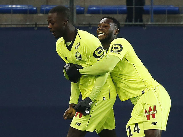 Lille's Ivorian forward Nicolas Pepe (L) celebrates scoring a goal with Lille's French forward Jonathan Bamba during the French L1 football match between Caen (SMC) and Lille (LOSC) on January 11, 2019, at the Michel d'Ornano Stadium, in Caen, northwestern France.