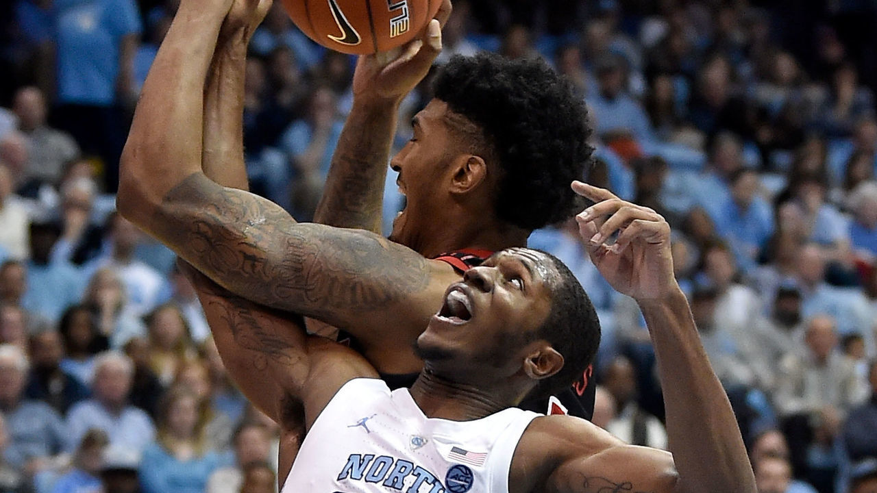 CHAPEL HILL, NORTH CAROLINA - JANUARY 12: Kenny Williams #24 of the North Carolina Tar Heels battles Malik Williams #5 of the Louisville Cardinals for a rebound during the first half of their game at the Dean Smith Center on January 12, 2019 in Chapel Hill, North Carolina.