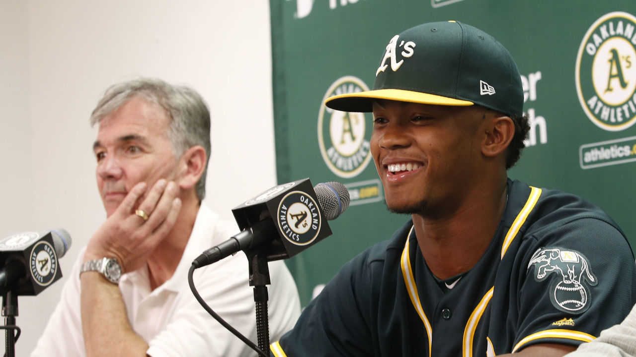 OAKLAND, CA - JUNE 15: Executive Vice President of Baseball Operations Billy Beane of the Oakland Athletics, first round draft pick Kyler Murray and Agent Scott Boras talk during a press conference after Murray signed his contact at the Oakland Alameda Coliseum on June 15, 2018 in Oakland, California.