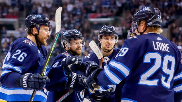 WINNIPEG, MB - JANUARY 13: Blake Wheeler #26, Josh Morrissey #44, Mark Scheifele #55 and Patrik Laine #29 of the Winnipeg Jets celebrate a first period goal against the Anaheim Ducks at the Bell MTS Place on January 13, 2019 in Winnipeg, Manitoba, Canada.