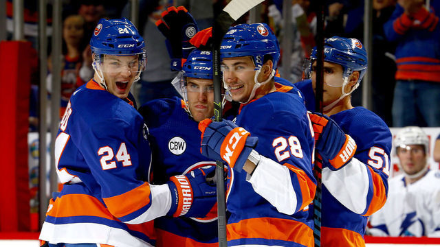 NEW YORK, NEW YORK - JANUARY 13: Devon Toews #25 of the New York Islanders is congratulated by his teammates Scott Mayfield #24, Michael Dal Colle #28 and Valtteri Filppula #51 after scoring a first period goal against the Tampa Bay Lightning at Barclays Center on January 13, 2019 in New York City.