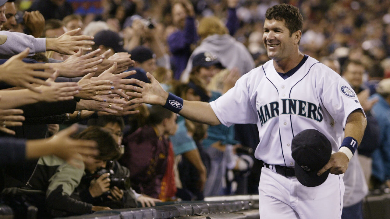 SEATTLE - OCTOBER 2: Edgar Martinez #11 of the Seattle Mariners is greeted by fans as he takes a lap around the field during a post game ceremony honoring his career as a Mariner on October 2 2004 at Safeco Field in Seattle, Washington.