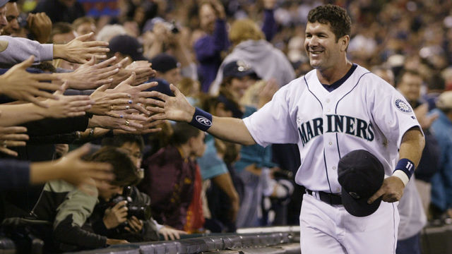 SEATTLE - OCTOBER 2: Edgar Martinez #11 of the Seattle Mariners is greeted by fans as he takes a lap around the field during a post game ceremony honoring his career as a Mariner on October 2 2004 at Safeco Field in Seattle, Washington.