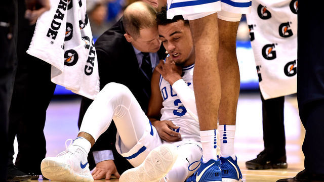DURHAM, NORTH CAROLINA - JANUARY 14: A trainer tends to Tre Jones #3 of the Duke Blue Devils after a collision on the floor during the first half of their game against the Syracuse Orange at Cameron Indoor Stadium on January 14, 2019 in Durham, North Carolina.