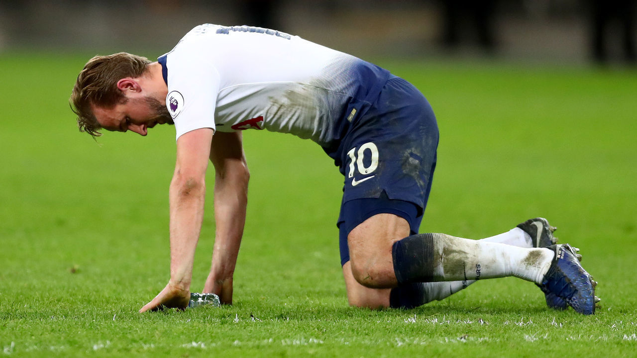 LONDON, ENGLAND - JANUARY 13: Harry Kane of Tottenham Hotspur struggles to get to his feet after a heavy challenge in the final moments of the Premier League match between Tottenham Hotspur and Manchester United at Wembley Stadium on January 13, 2019 in London, United Kingdom.
