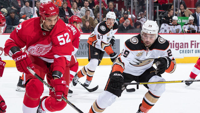 DETROIT, MI - JANUARY 15: Jonathan Ericsson #52 of the Detroit Red Wings skates with the puck in front of Devin Shore #29 of the Anaheim Ducks during an NHL game at Little Caesars Arena on January 15, 2019 in Detroit, Michigan.