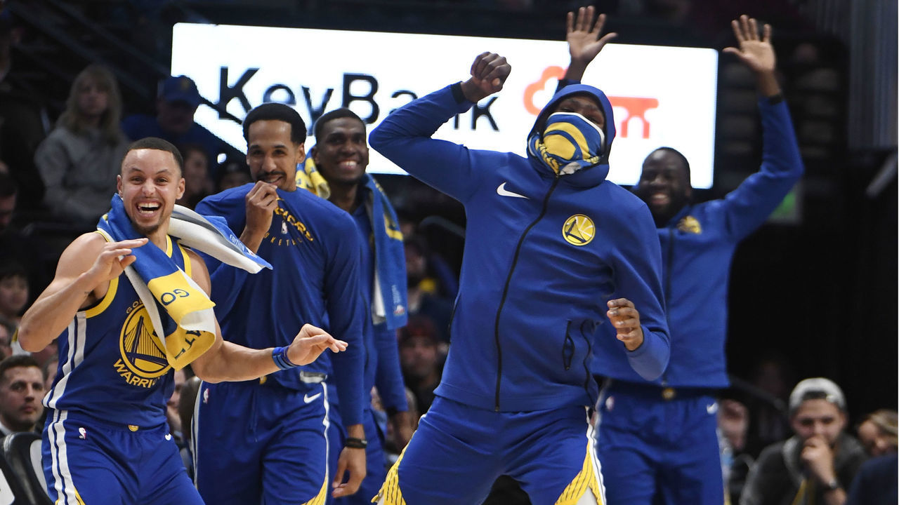 DENVER, CO - JANUARY 15: Golden State Warriors guard Stephen Curry (30), left, and forward Kevin Durant (35), right, celebrate a dunk by teammate Golden State Warriors guard Klay Thompson (11) (not pictured) against the Denver Nuggets in fourth quarter at the Pepsi Center January 15, 2019. The Nuggets lost 142-111.