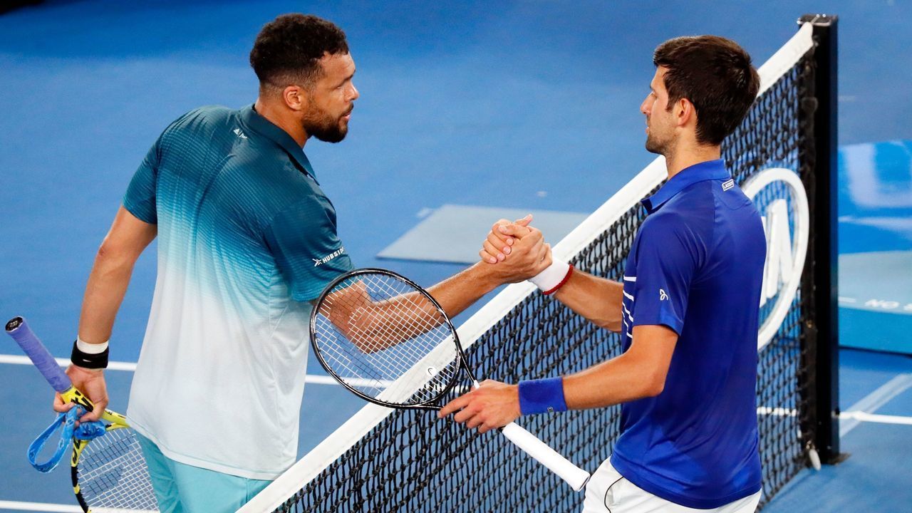 Serbia's Novak Djokovic (R) shakes hand with France's Jo-Wilfried Tsonga after their men's singles match on day four of the Australian Open tennis tournament in Melbourne early January 18, 2019.
