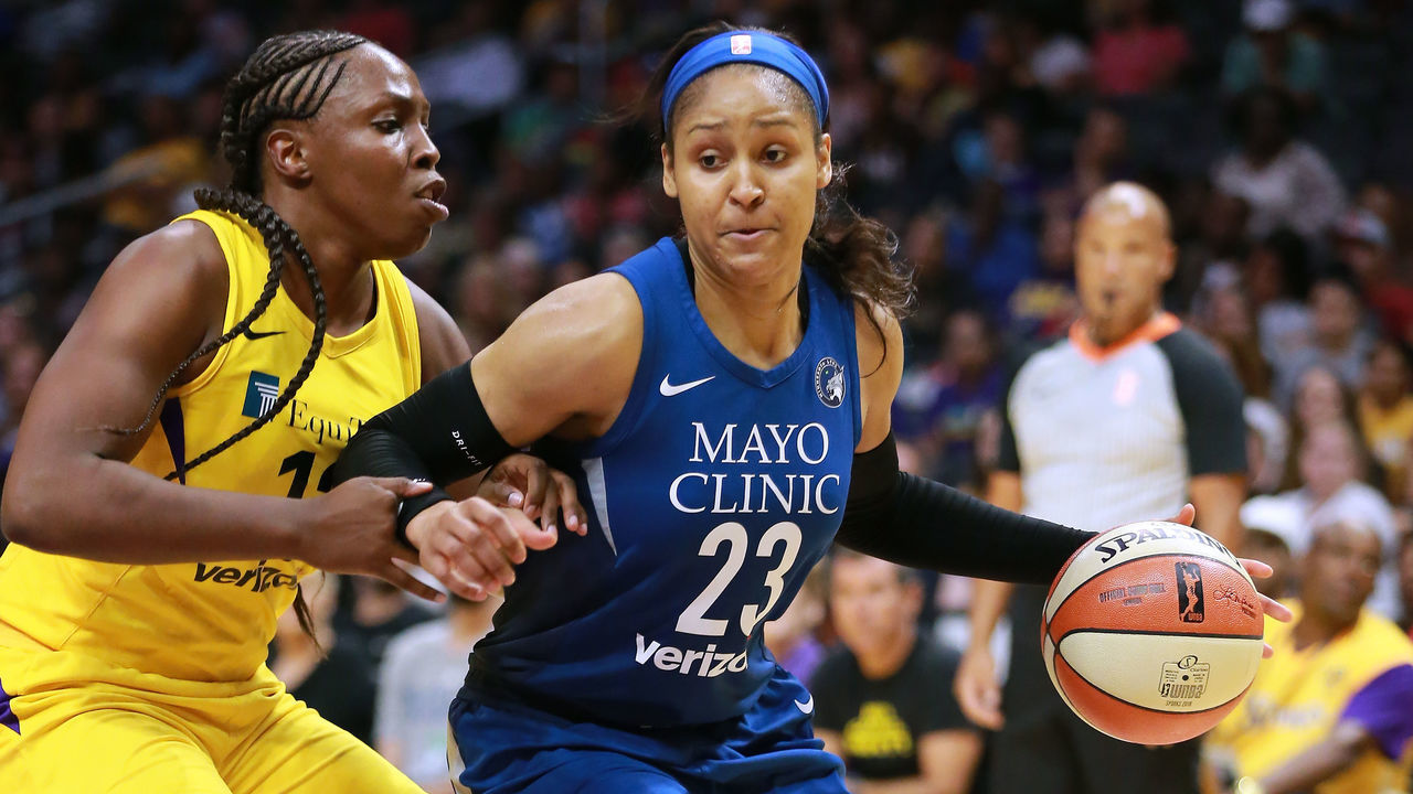 LOS ANGELES, CA - AUGUST 21: Maya Moore #23 of the Minnesota Lynx handles the ball against Chelsea Gray #12 of the Los Angeles Sparks in Round One of the 2018 WNBA Playoffs at Staples Center on August 21, 2018 in Los Angeles, California.