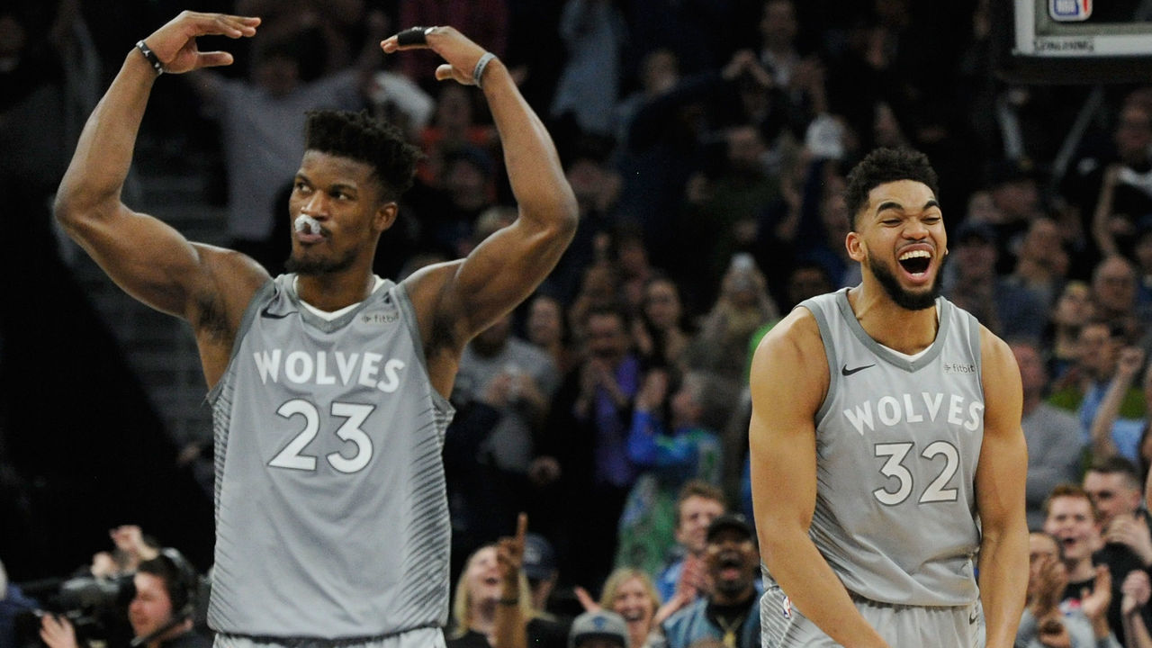 MINNEAPOLIS, MN - APRIL 11: Jimmy Butler #23 and Karl-Anthony Towns #32 of the Minnesota Timberwolves celebrate in the final minute of overtime of the game against the Denver Nuggets on April 11, 2018 at the Target Center in Minneapolis, Minnesota. The Timberwolves defeated the Nuggets 112-106.