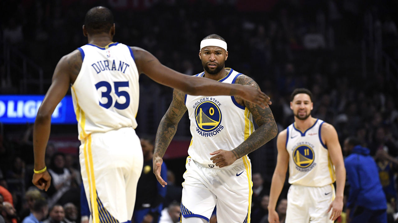 LOS ANGELES, CA - JANUARY 18: DeMarcus Cousins #0 of the Golden State Warriors is congratulated by Kevin Durant #35 after scoring his first pints as a member of the Golden State Warriors against Los Angeles Clippers during the first half at Staples Center on January 18, 2019 in Los Angeles, California.