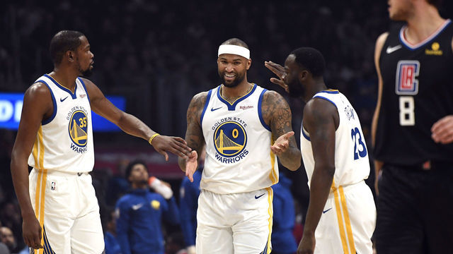 LOS ANGELES, CA - JANUARY 18: DeMarcus Cousins #0 of the Golden State Warriors is congratulated by Kevin Durant #35 and Draymond Green #23 after scoring a basket against Los Angeles Clippers during the first half at Staples Center on January 18, 2019 in Los Angeles, California.