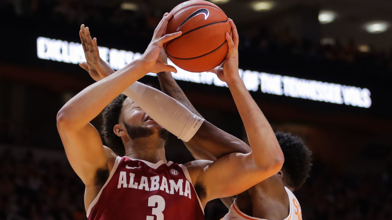 KNOXVILLE, TN - JANUARY 19: Alex Reese #3 of the Alabama Crimson Tide drives the lane with Admiral Schofield #5 of the Tennessee Volunteers defending during the first half of their game at Thompson-Boling Arena on January 19, 2019 in Knoxville, Tennessee.