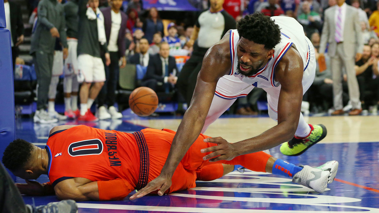 PHILADELPHIA, PA - JANUARY 19: Joel Embiid #21 of the Philadelphia 76ers fouls Russell Westbrook #0 of the Oklahoma City Thunder during the second half of a game at Wells Fargo Center on January 19, 2019 in Philadelphia, Pennsylvania. The Thunder defeated the Sixers 117-115.