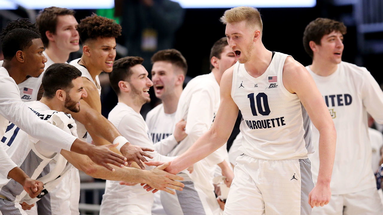 MILWAUKEE, WISCONSIN - JANUARY 20: Sam Hauser #10 of the Marquette Golden Eagles celebrates with his teammates in the second half against the Providence Friars at the Fiserv Forum on January 20, 2019 in Milwaukee, Wisconsin.