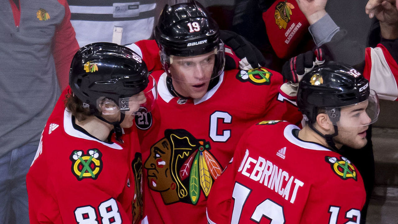 CHICAGO, IL - JANUARY 20: Chicago Blackhawks center Jonathan Toews (19) celebrates his hat-trick goal with Chicago Blackhawks right wing Patrick Kane (88) and Chicago Blackhawks left wing Alex DeBrincat (12) after scoring against Washington Capitals goaltender Pheonix Copley (1) during a game between the Washington Capitals and the Chicago Blackhawks on January 20, 2019, at the United Center in Chicago, IL.