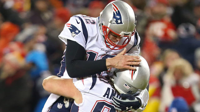 KANSAS CITY, MO - JANUARY 20: New England Patriots quarterback Tom Brady (12) leaps into the arms of center David Andrews (60) after throwing a 29-yard touchdown pass to New England Patriots wide receiver Phillip Dorsett (13) with 0:27 left in the second quarter of the AFC Championship Game game between the New England Patriots and Kansas City Chiefs on January 20, 2019 at Arrowhead Stadium in Kansas City, MO.
